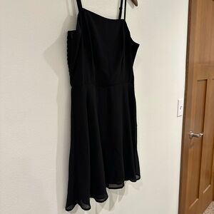 Black mini dress, fit and flare with adjustable spaghetti straps and ruched back